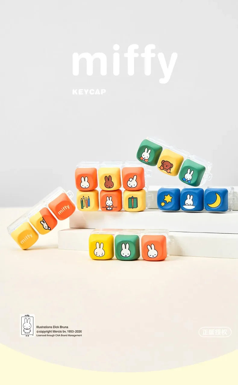 A collection of Miffy keycap pendants in various colors and shapes displayed on a white box.