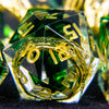 A close-up of a set of resin dice with golden elven numbers, featuring green and yellow tones.