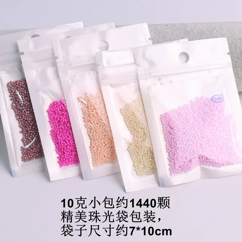 A collection of 1440 pieces of various colored glass seed beads packaged in small plastic bags.