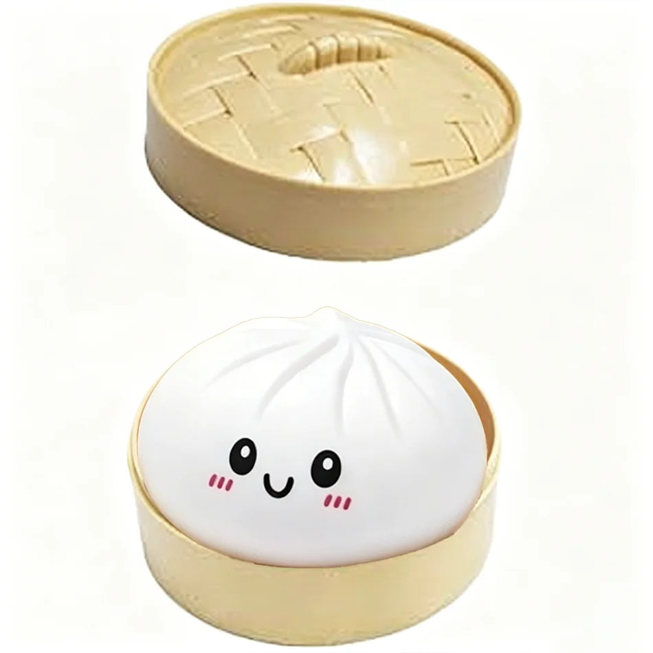 A white glitter dumpling squishy stress relief toy in a light beige container.