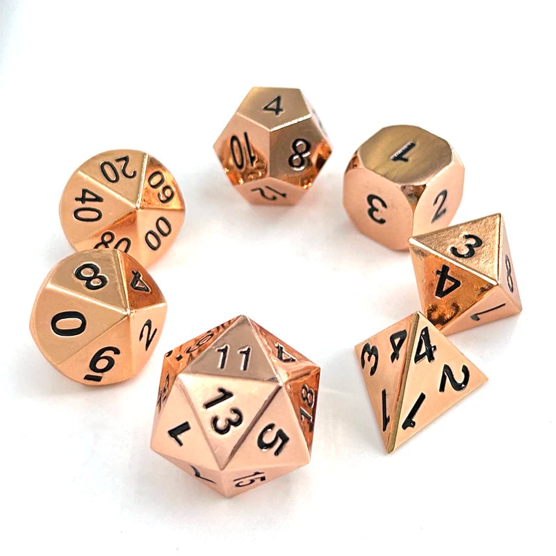 A collection of premium metal polyhedral dice in a multicolor gold finish arranged on a white background.