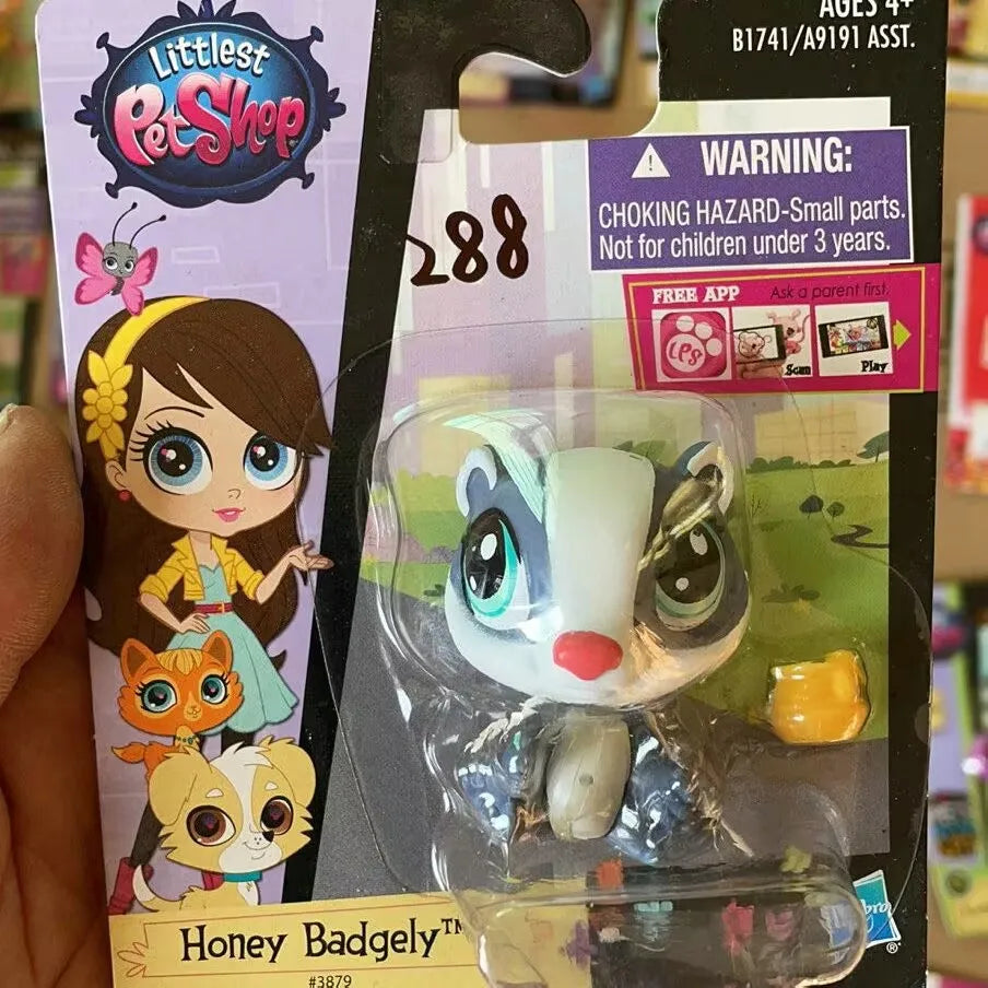 A packaged set of three small animal figures, including a brown bear, a white animal, and a yellow animal, for sale.