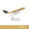 A diecast model of a Saudi Arabian airplane with gold and white livery.