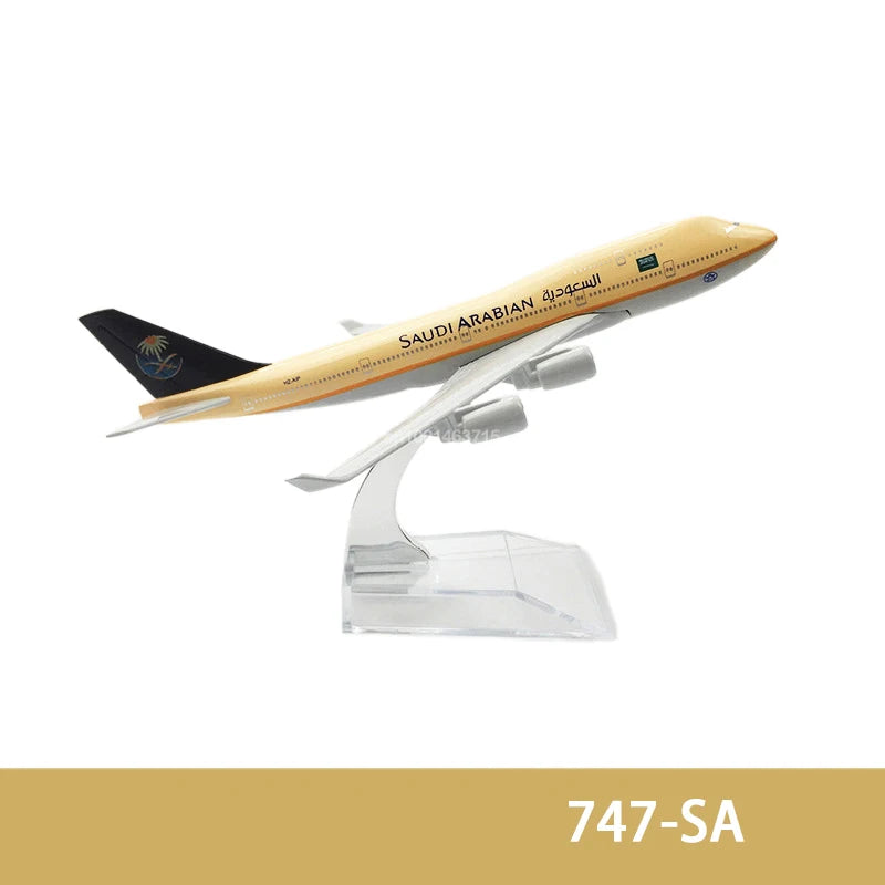 A diecast model of a Saudi Arabian airplane with gold and white livery.