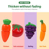 A set of plastic fruits and vegetables including a tomato, strawberry, grape, and carrot for pretend play.