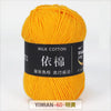 A ball of bright yellow milk cotton yarn labeled YIMIAN 60 明黃 for knitting and crochet.