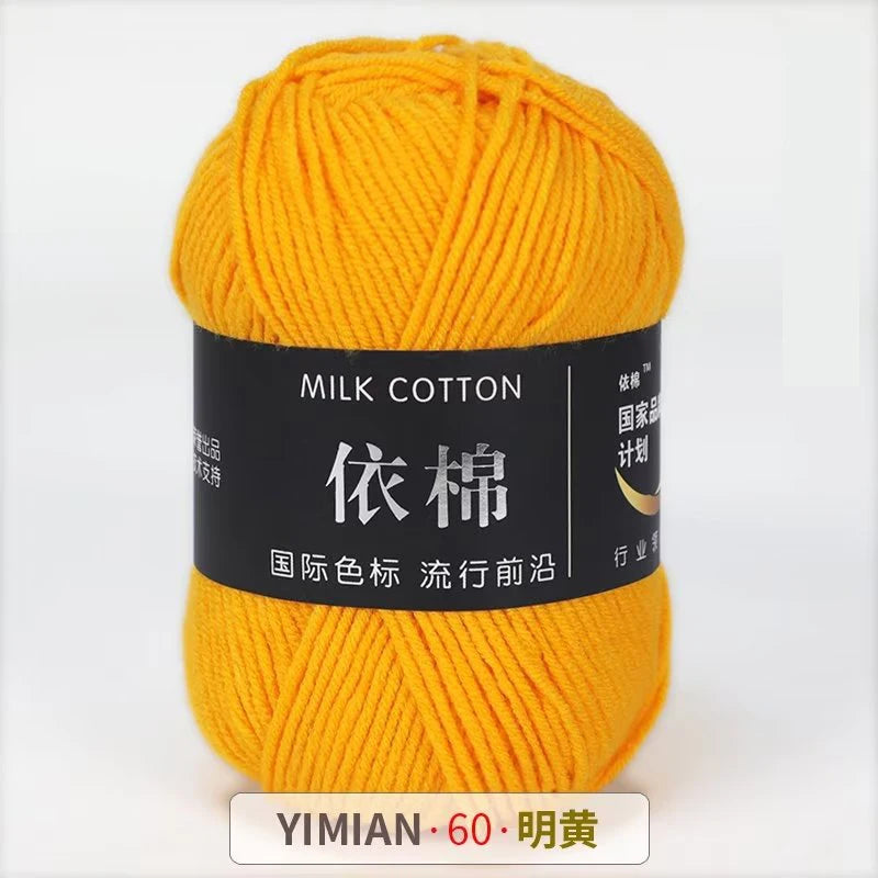 A ball of bright yellow milk cotton yarn labeled YIMIAN 60 明黃 for knitting and crochet.