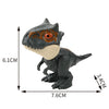 A dark gray finger dinosaur fidget toy with an orange eye and a light beige snout, shown from the side.