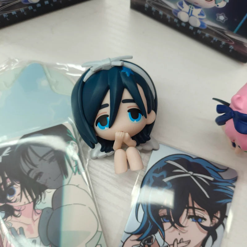 A blind box figure of a blue-haired character with large blue eyes and white hair, packaged in clear plastic.