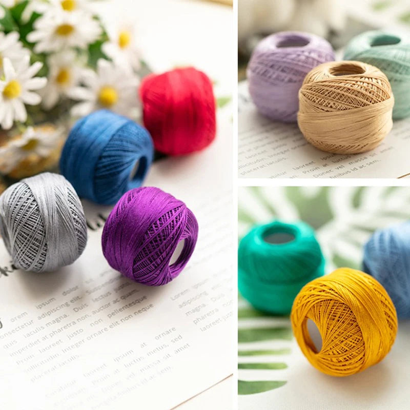 A collection of various colored cotton crochet thread spools, including red, blue, purple, gray, and yellow.