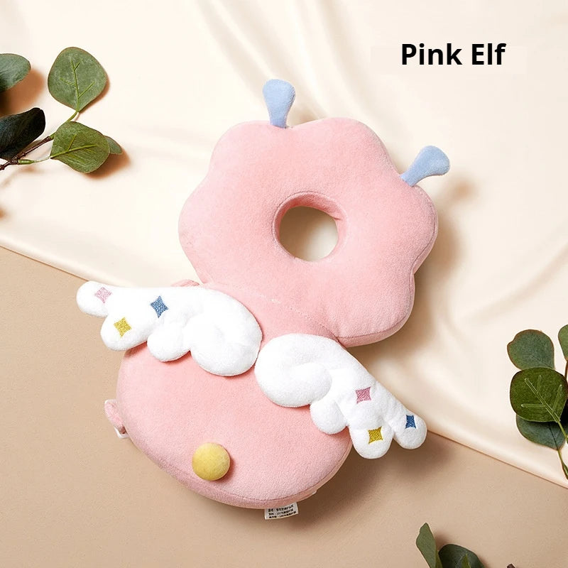 Pink Elf soft silicone head protection pillow for baby with white wings and yellow accents