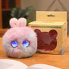 A pink plush rabbit pendant is displayed next to its packaging box.