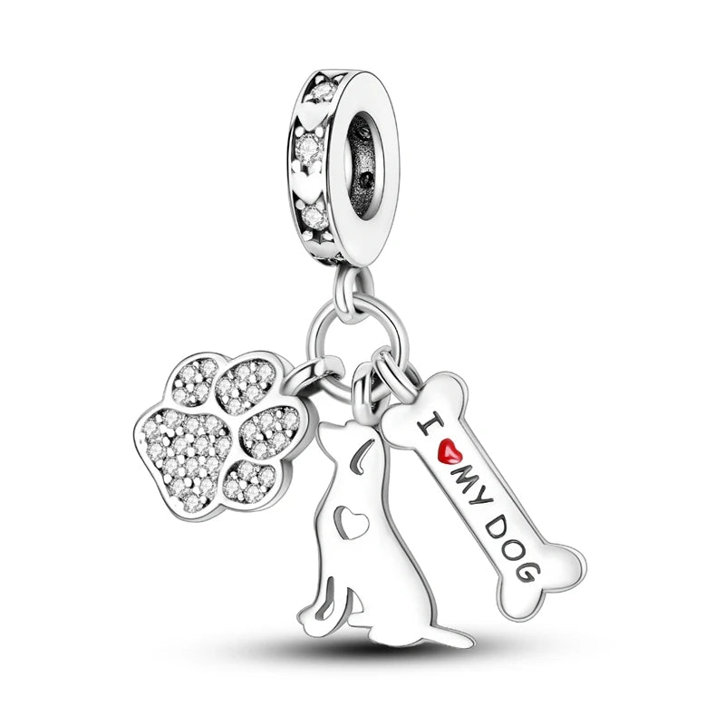 A sterling silver charm bead featuring a paw print and a silhouette of a dog.