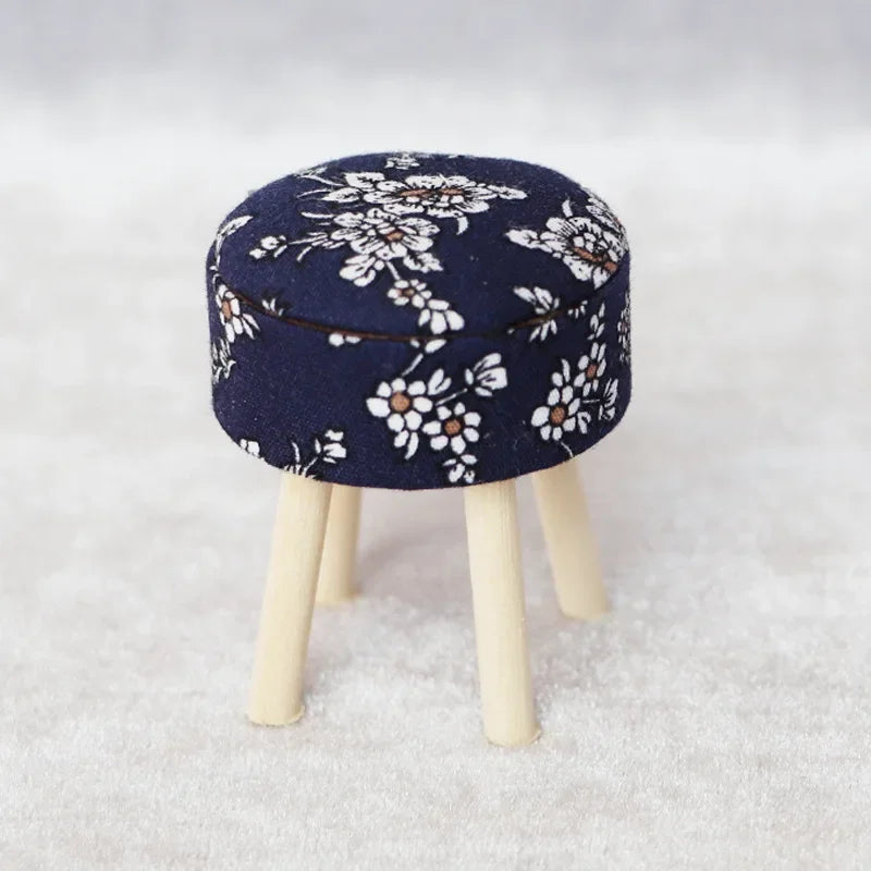 A navy blue floral patterned mini sofa and pillow set for a dollhouse
