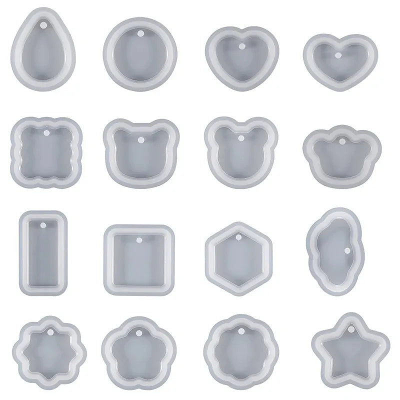 A collection of heart-shaped silicone molds for resin jewelry making in a light gray color.