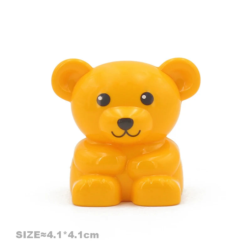 A yellow lion building block toy with large ears and a smiling face.
