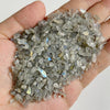 A handful of clear and translucent gray natural tumbled stone chips for jewelry making
