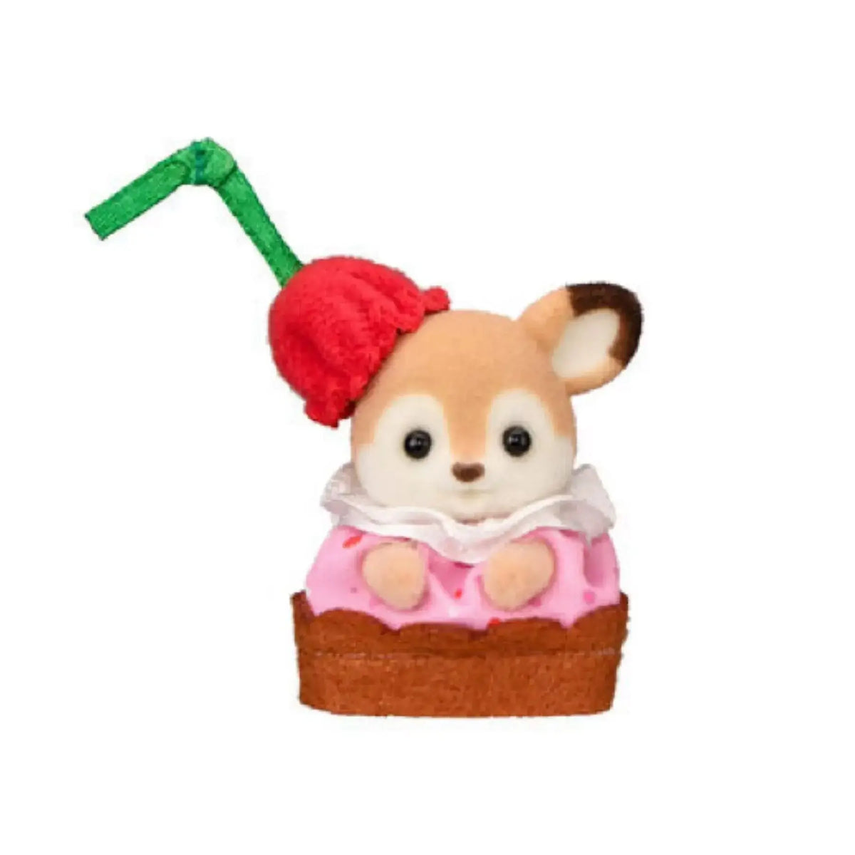 Figure de famille Sylvanian Families, renard avec des oreilles vertes et un pompon rouge, assis sur un gâteau rose.