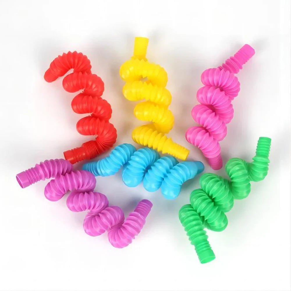 A collection of colorful, squeezable pop tubes in red, yellow, pink, blue, and green.