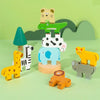 A set of wooden animal figures, including a tiger, dinosaur, giraffe, zebra, and elephant, stacked on a green background.