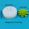 A white silicone mold shaped like a cactus or succulent, next to a green silicone mold.