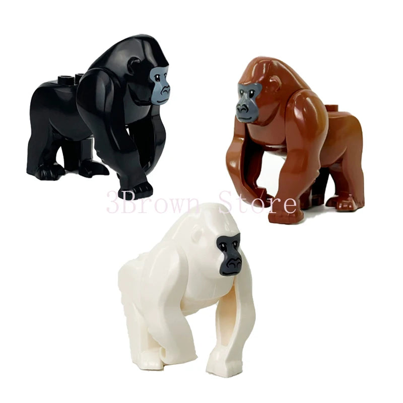 A set of three African wildlife animal building blocks: a black gorilla, a brown orangutan, and a white elephant.