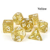 A set of seven yellow polyhedral acrylic dice, including d6s and d10s, scattered on a white surface.