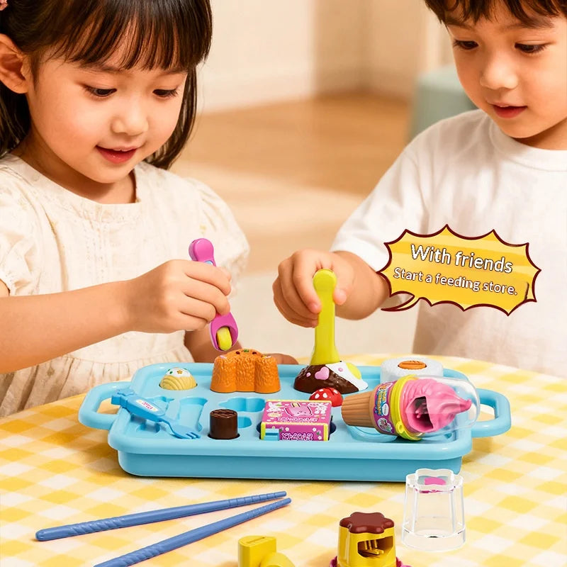 Two children play with a strawberry pudding pretend play kitchen set featuring various food items and tools.