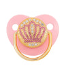 A pink pacifier featuring rose gold crystal bling and a gold ring for newborns.