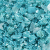 A close-up of iridescent blue acrylic beads shaped like flowers and butterflies for DIY jewelry making