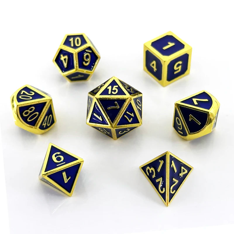 A collection of ten polyhedral dice in blue and gold metal finish scattered on a white surface.