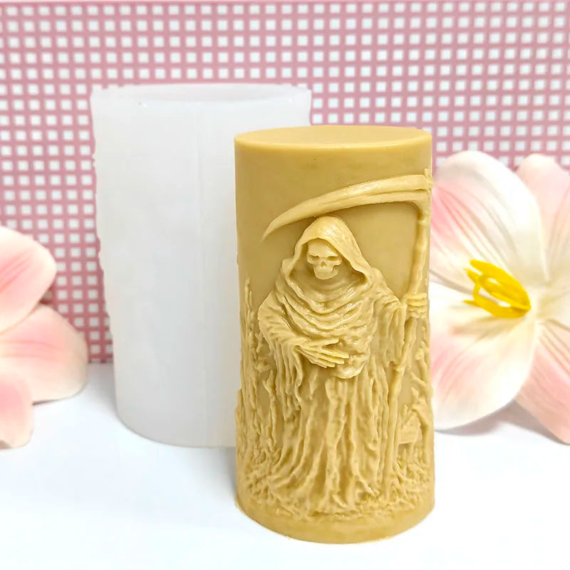 A light beige silicone candle mold shaped like a hooded skull with a Gothic death angel design.