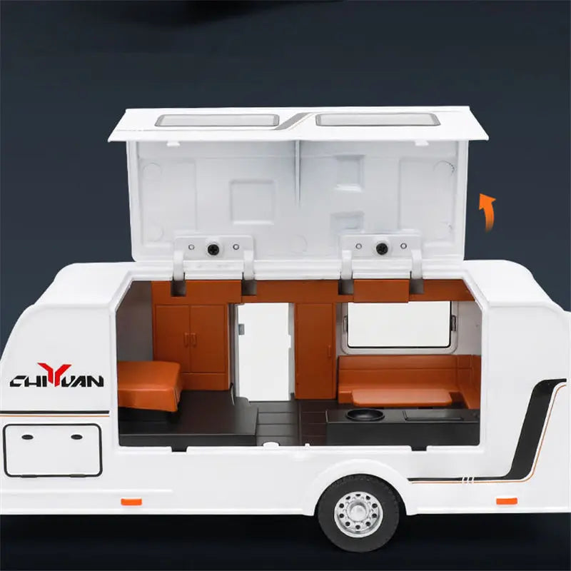 A white diecast metal RV camper truck model with an open top showing the interior and kitchen setup.