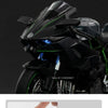 Close-up of a black diecast sport motorcycle model with a green lighting effect display.