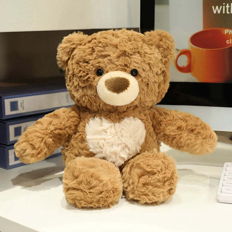 A brown teddy bear plush toy with a light tan snout and a white chest sitting on a white surface.