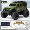 A green 1:64 scale off-road RC car model with a black body, large tires, and remote control accessories.