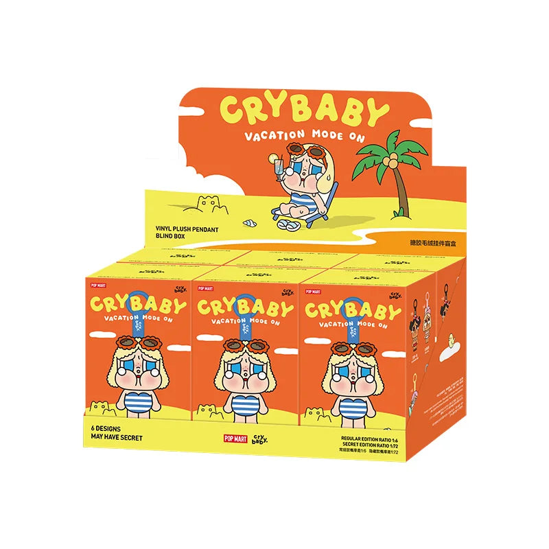 A box of Crybaby Vacation Mode On vinyl plush pendant blind boxes featuring various designs.