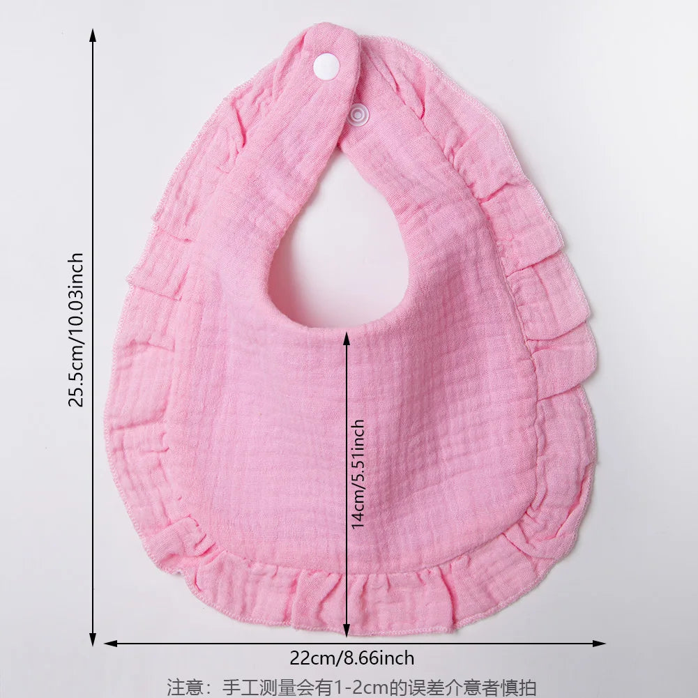 Pink ruffled muslin cotton baby bib with adjustable snap closure