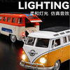 A close-up of a vintage style metal bus diecast model in white and orange colors with pull-back action.