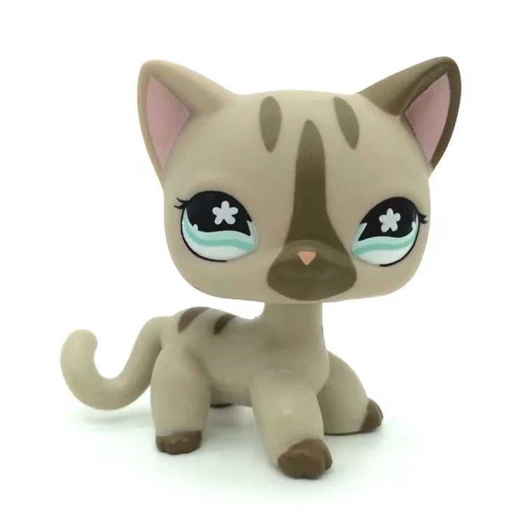 A small, light brown and tan Littlest Pet Shop style standing dog figure.
