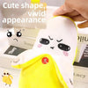 A yellow and white plush toy with a cute, expressive face is shown being held by a hand.