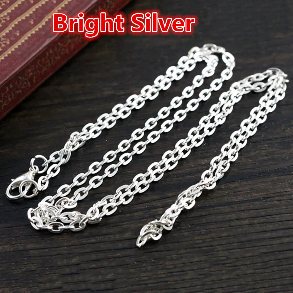 Bright silver flattened chain connector for jewelry making displayed on a dark wooden surface.