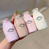 A hand holds three pink and white Chiboki drink cups, a fruit bottle stress ball set.