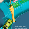 An orange fork used for analog line switching is shown on a teal playset with a green car.