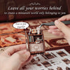 Hands assemble a wooden miniature book nook kit for DIY crafting