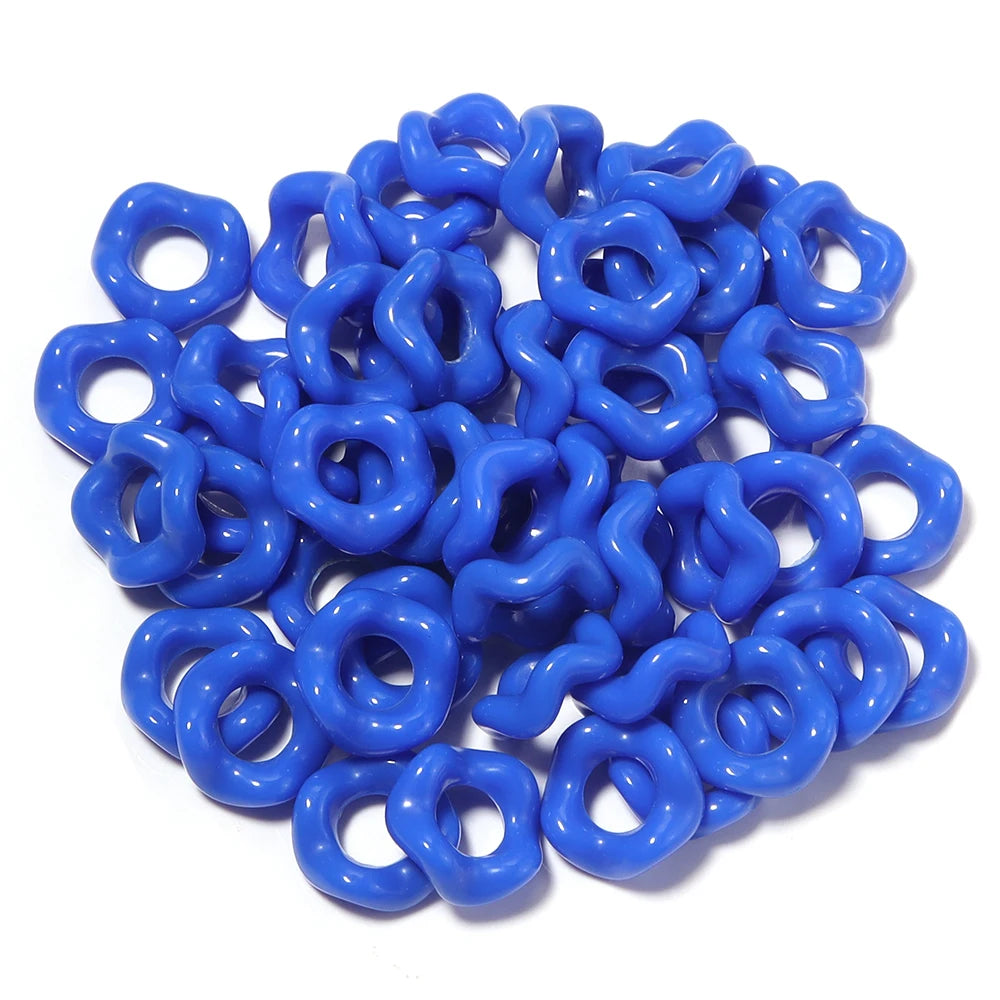 A pile of bright blue acrylic doughnut spacer beads for jewelry making