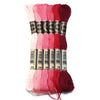 A set of six skeins of vibrant embroidery thread in various shades of pink and red for cross stitch and DIY crafts