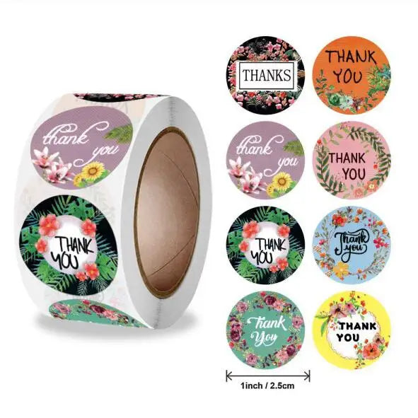 Roll of colorful round thank you stickers in various floral patterns for gifts and packaging