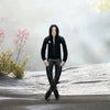 A black plush doll resembling Michael Jackson with a hood and gloves standing in a snowy outdoor setting.