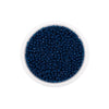 A clear container filled with dark blue Czech glass seed beads for jewelry making